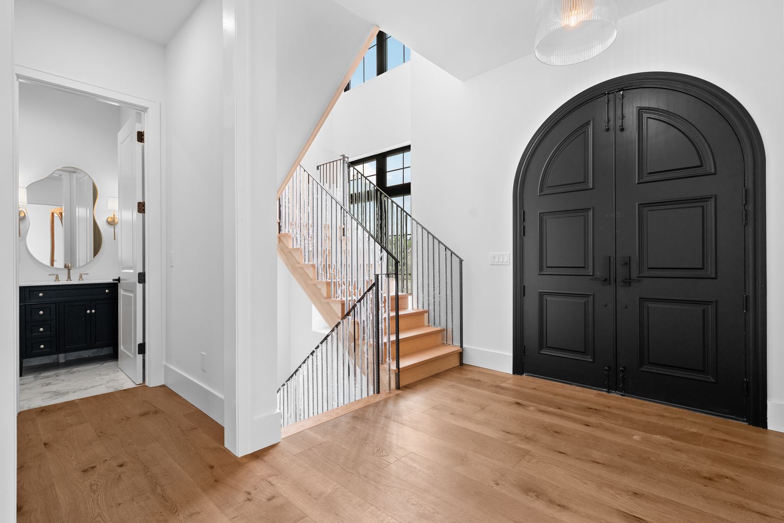 Staircase and foyer with wrought iron railing