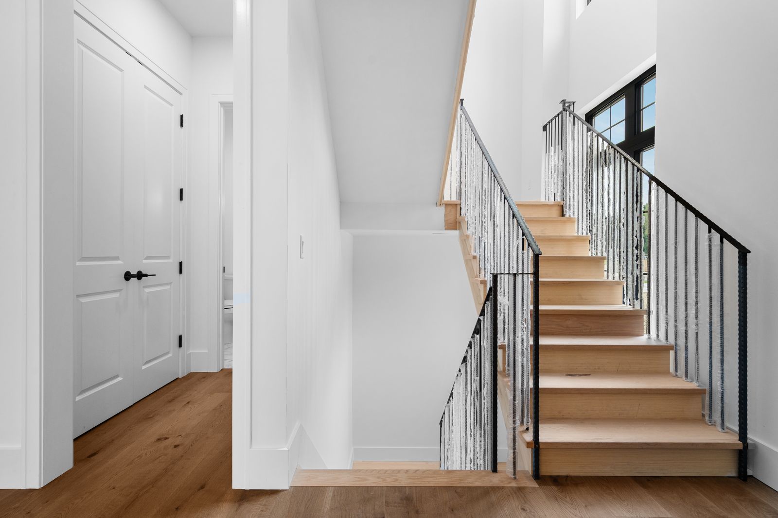 Staircase detail with wood treads and iron balusters