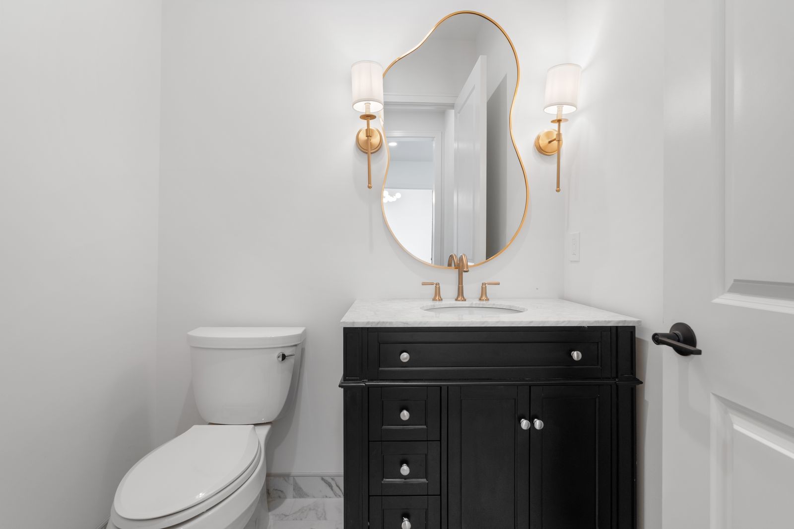 Powder bathroom with black vanity