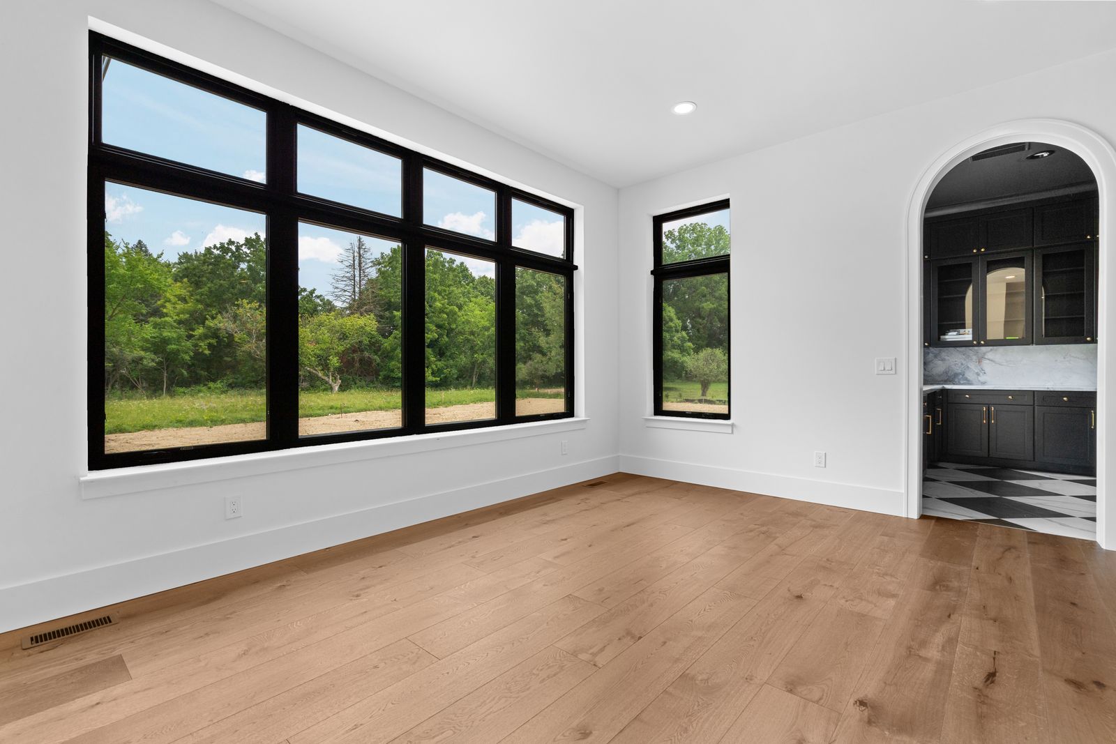 Great room with large windows and wood flooring