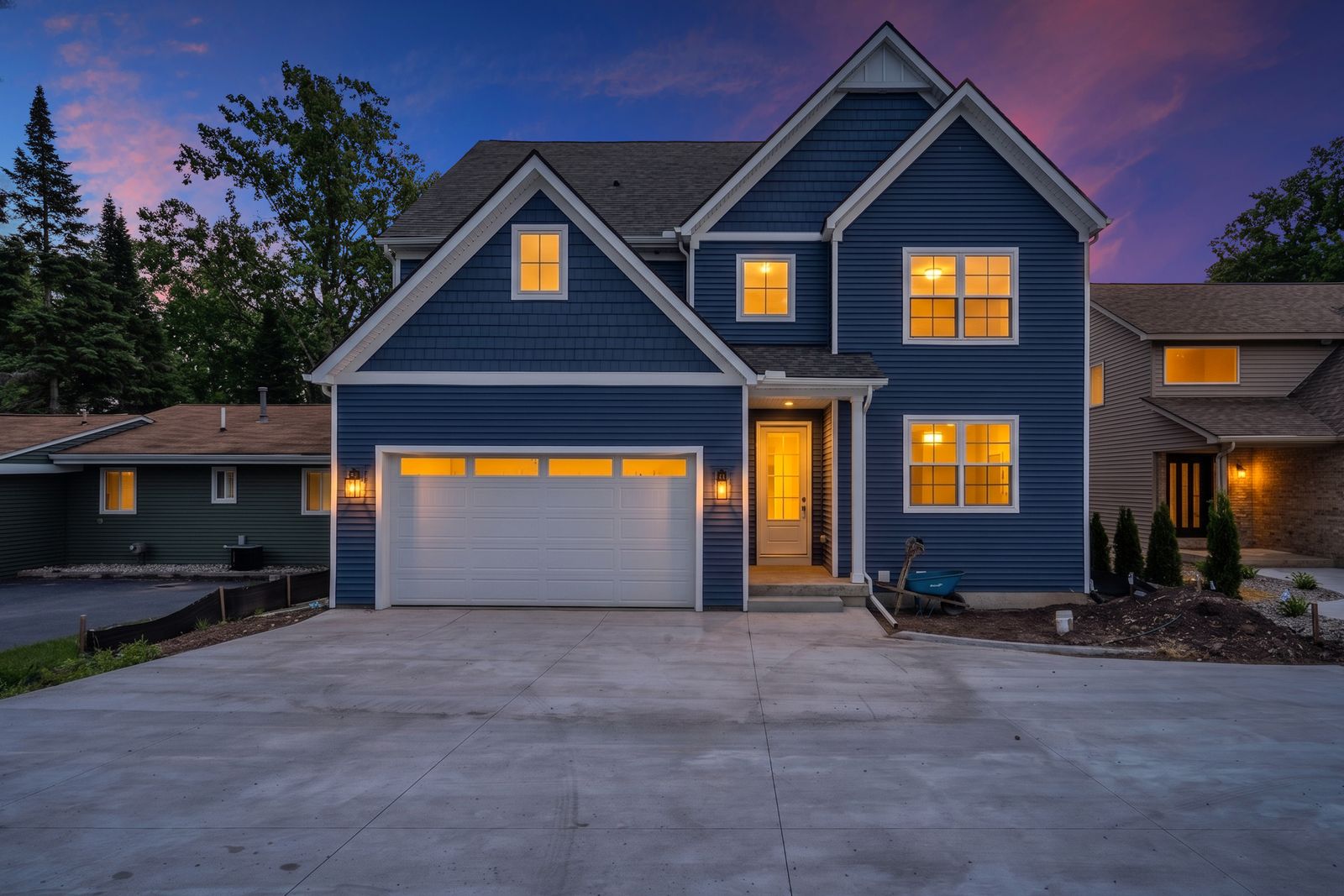 Front exterior at dusk with warm interior lighting