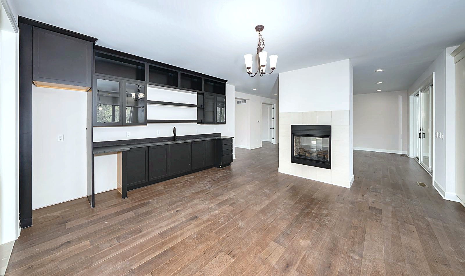 Kitchen with dark cabinetry adjoining the fireplace