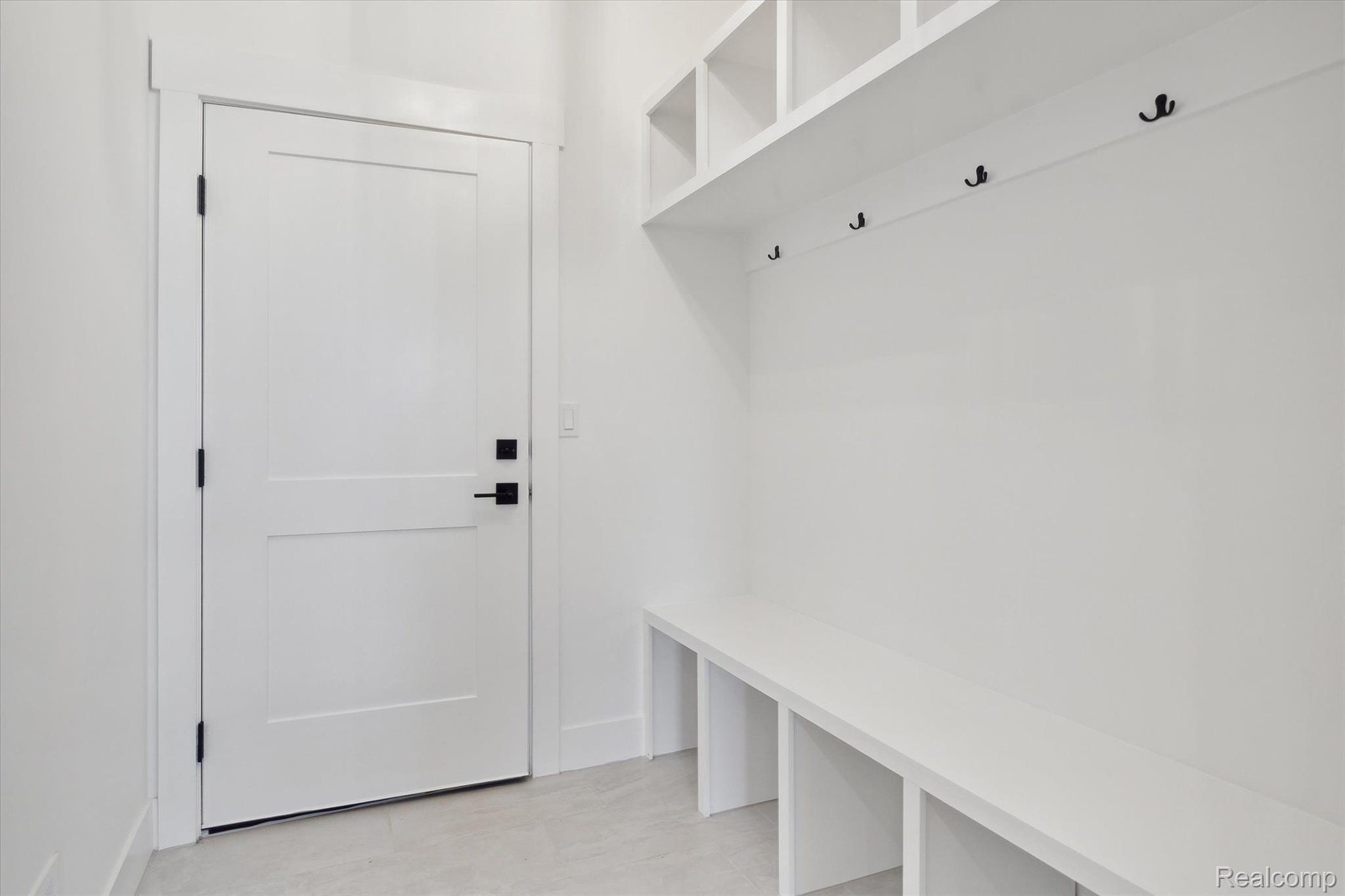 Mudroom with built-in bench and lockers