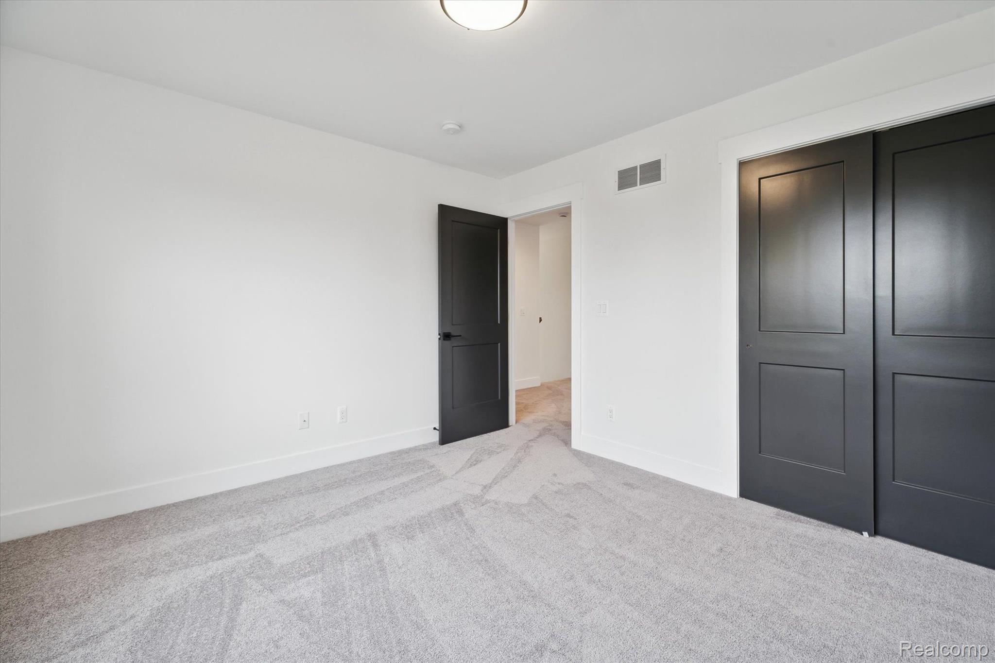 Bedroom with black accent doors
